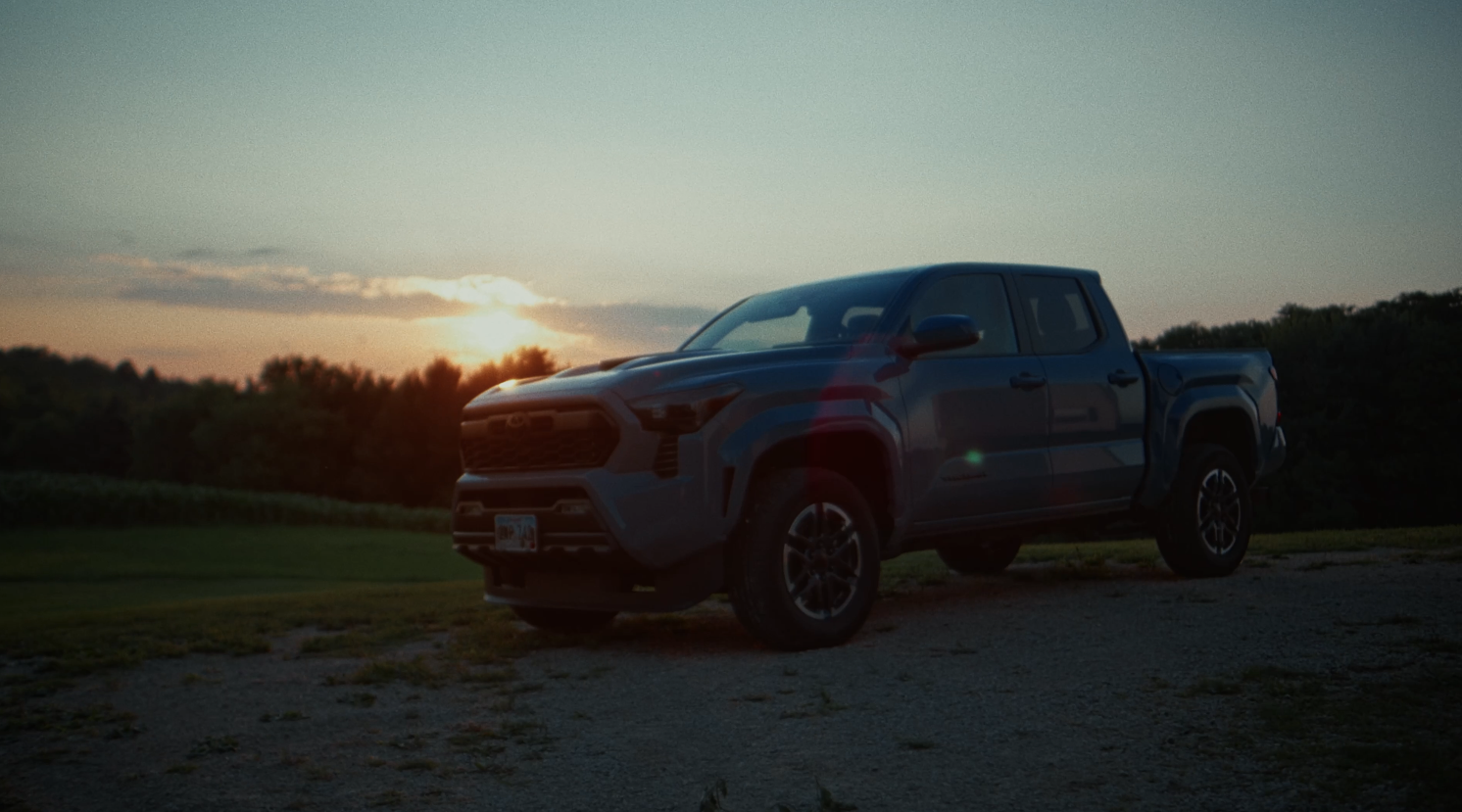 Blue Toyota Tacoma at sunset