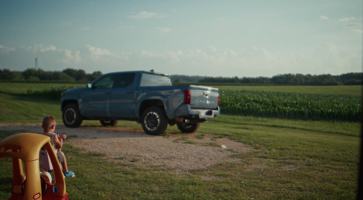 Blue Toyota Tacoma beside a Midwest field