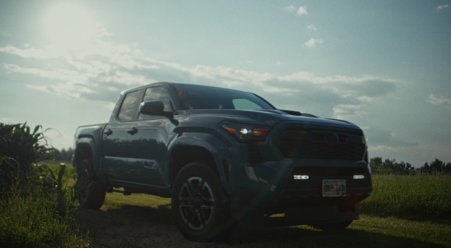 Blue Toyota Tacoma on a farm road